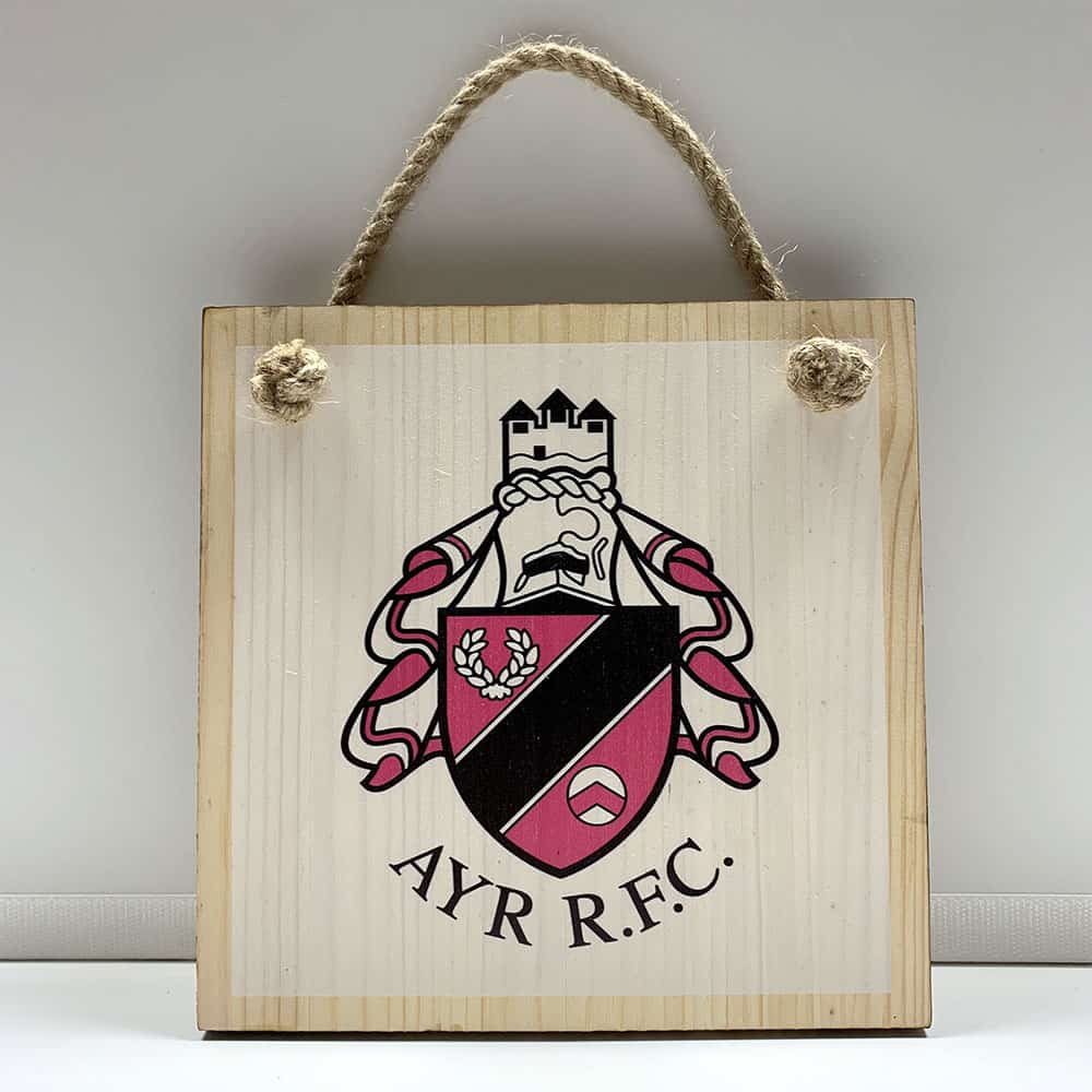 square wooden plaque with ayr rugby club logo and rope